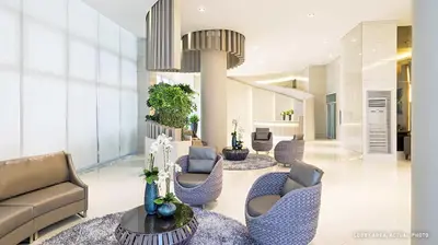 a lobby with couches and chairs in a building at Grace Residences Elevate Escapes - near BGC airport in Manila