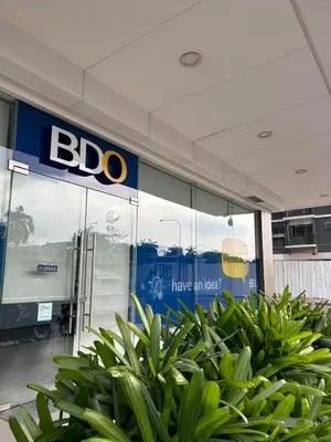 a bdo store with green plants in front of it at Mall of Asia Shore Dynastel Staycation in Manila