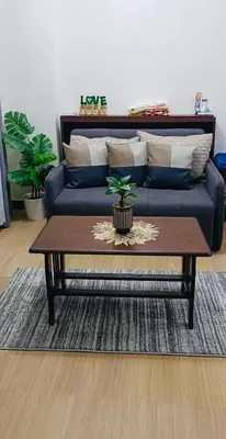 a living room with a couch and a coffee table at Davids Suite at Hope Residences Trece Martires Cavite in Trece Martires
