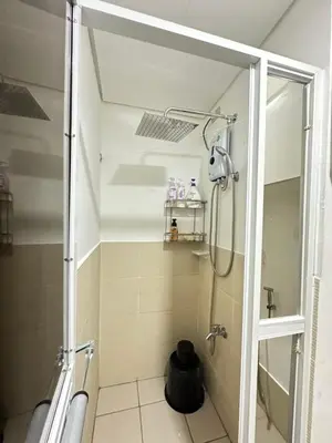 a shower with a glass door in a bathroom at Davids Suite at Hope Residences Trece Martires Cavite in Trece Martires