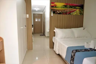 a bedroom with a bed and a painting on the wall at Shore Residences MOA Dynastel Staycation in Manila