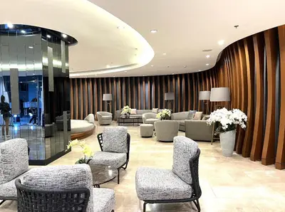 a lobby with chairs and couches in a building at Shore Residences MOA Dynastel Staycation in Manila
