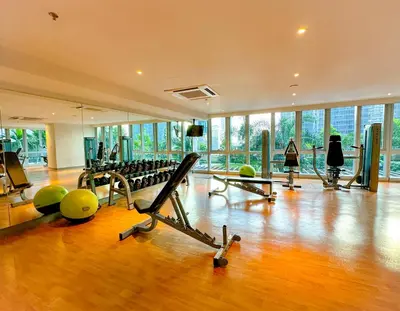 a gym with a lot of treadmills and exercise equipment at 1BR BGC Uptown Modern Condo Netflix 200Mb Wifi in Manila