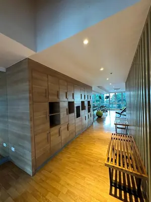 a room with wooden cabinets and a bench in it at 1BR BGC Uptown Modern Condo Netflix 200Mb Wifi in Manila