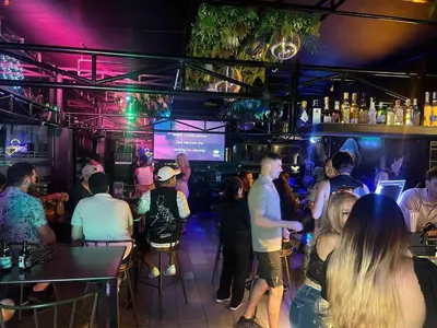 a group of people sitting in a bar at Mad Monkey Manila in Manila