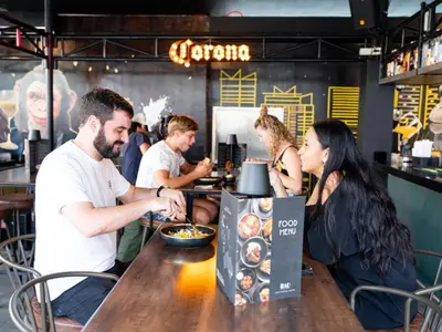a group of people sitting at a table in a restaurant at Mad Monkey Manila in Manila