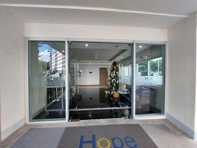 a large glass building with a christmas tree in it at Sojourn at SMDC Hope Residences in Trece Martires