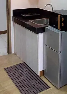 a small kitchen with a sink and a dishwasher at Sojourn at SMDC Hope Residences in Trece Martires