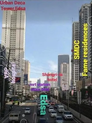 a city street with cars and signs in a city at Hassle Free Check In and Out With Unli WiFi Netflix in Manila