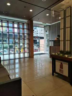 a lobby of a building with windows and a table at Hassle Free Check In and Out With Unli WiFi Netflix in Manila
