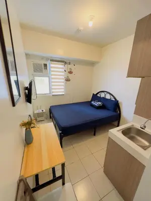 a small room with a blue bed and a sink at Hassle Free Check In and Out With Unli WiFi Netflix in Manila