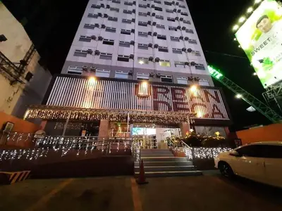 a large building with christmas lights in front of it at Hassle Free Check In and Out With Unli WiFi Netflix in Manila