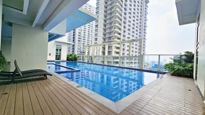 a swimming pool on the balcony of a building at Stylish and Spacious Studio Unit in Makati with Fast Wi-Fi in Manila