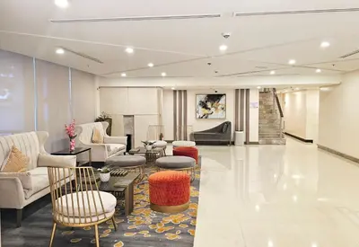 a lobby with couches chairs and tables in a building at Stylish and Spacious Studio Unit in Makati with Fast Wi-Fi in Manila