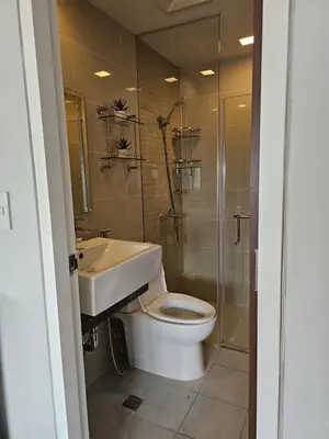 a bathroom with a toilet and a sink and a shower at Stylish and Spacious Studio Unit in Makati with Fast Wi-Fi in Manila
