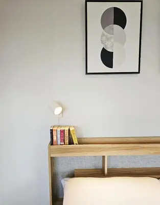 a bedroom with a bed and a picture on the wall at Stylish and Spacious Studio Unit in Makati with Fast Wi-Fi in Manila