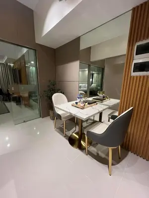 a dining room with a table and chairs at Hotel Vibe Condo at Uptown Parksuites BGC in Manila