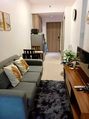 a living room with a couch and a television at Cozy 1BR w/Wifi&Netflix in FAME near Shaw MRT in Manila