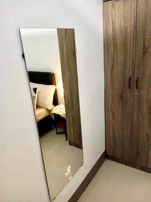 a mirror in the corner of a room with a bed at Cozy 1BR w/Wifi&Netflix in FAME near Shaw MRT in Manila