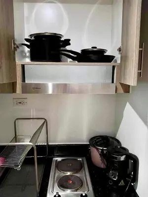 a stove top with pots and pans in a kitchen at Cozy 1BR w/Wifi&Netflix in FAME near Shaw MRT in Manila