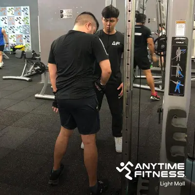 a group of men in a gym working out at Ever Stays at Light Residences 1BR in Manila