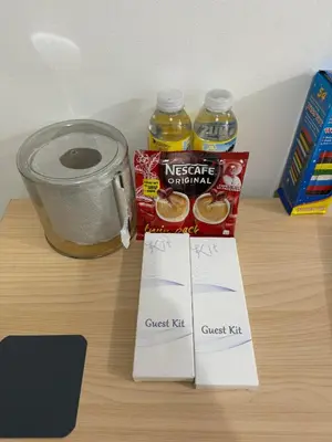 a counter with a jar of honey and a cup of juice at Ever Stays at Light Residences 1BR in Manila