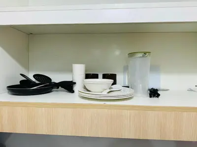 a shelf with plates and a blender on it at Ever Stays at Light Residences 1BR in Manila