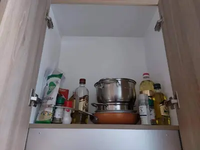 a cupboard filled with lots of food and spices at Little Lux Condo Shore 2-T3 Improved in Manila