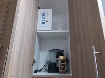 a cupboard with a coffee maker and a box at Little Lux Condo Shore 2-T3 Improved in Manila