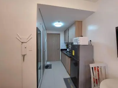 a small kitchen with a refrigerator and a microwave at Little Lux Condo Shore 2-T3 Improved in Manila