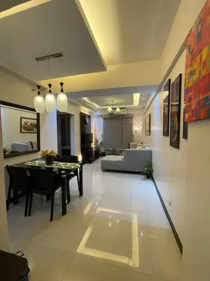 a living room with a table and a dining room at Montecito Luxury 1 bedroom condominium in Manila