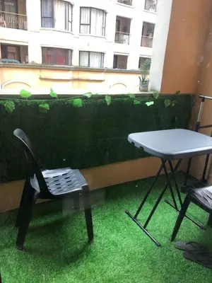 a chair and a table in front of a building at Montecito Luxury 1 bedroom condominium in Manila