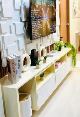 a white console table with plants and a tv at Stylist Luxe Condo near Mall of Asia - Shore 3 in Manila