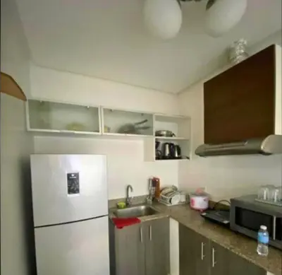 a small kitchen with a refrigerator and a sink at FREE Pool n FREE Sauna Access OceanView Balcony in The Heart of Manila, Front of Robinsons Mall, Walking Distance to US Embassy Limited Slots x Secure Your Limited Offer This Month in Manila