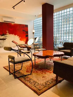 a living room with chairs and a table and a rug at Cayco House by Hotel Durban in Manila