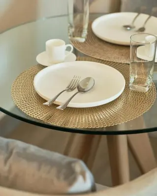 a glass table with plates and silverware on it at BGC Suite with Golf Course View in Manila