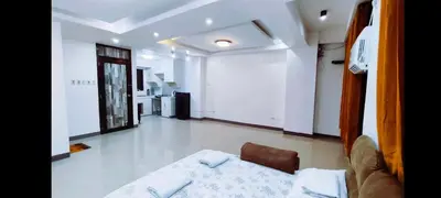 a living room with a bed and a couch in it at Masterpiece Staycation Makati in Manila