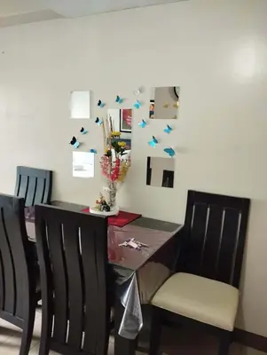 a dining room table and chairs with blue stars on the wall at Palm Tree Villas - Studio Unit in Manila