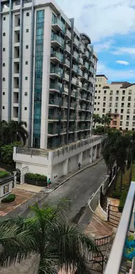 a large white building with a street in front of it at Palm Tree Villas - Studio Unit in Manila