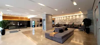 a lobby with a couch and chairs in a building at Premier Luxury Suite near SM Mall of Asia Arena & DFA with Free Parking in Manila