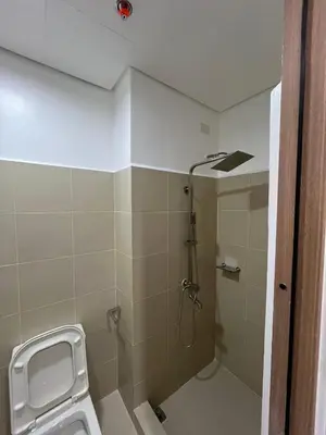 a bathroom with a shower and a toilet at Premier Luxury Suite near SM Mall of Asia Arena & DFA with Free Parking in Manila