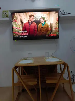 a flat screen tv hanging on a wall at Rose condotel Newport in Manila