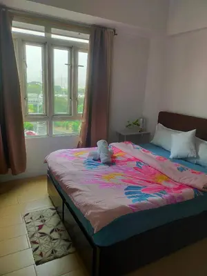 a bedroom with a bed with a stuffed animal on it at Rose condotel Newport in Manila