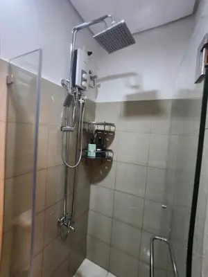 a shower with a shower head in a bathroom at Goshen E320 in Manila