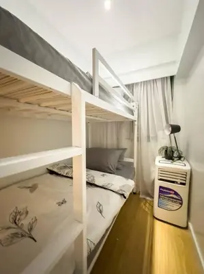 a bedroom with two bunk beds and a desk at A2J Luxury 2BR BGC Suite Near High Street, Malls in Manila