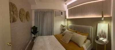 a bedroom with a bed in a room with at Luxury 1 BR Suite Near NAIA in Manila