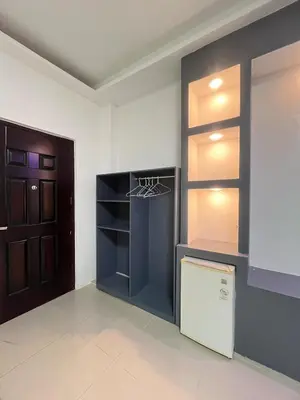 an empty kitchen with a refrigerator and a door at Shiri Hotel in Silang