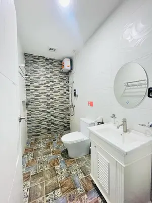 a bathroom with a sink and a toilet at Shiri Hotel in Silang