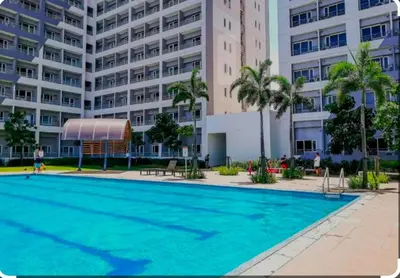 a large swimming pool in front of a building at Grace Residences Condotel Paris & Singapore Concept Near McKinley in Manila