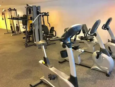a gym with several exercise bikes and tread machines at Grace Residences Condotel Paris & Singapore Concept Near McKinley in Manila